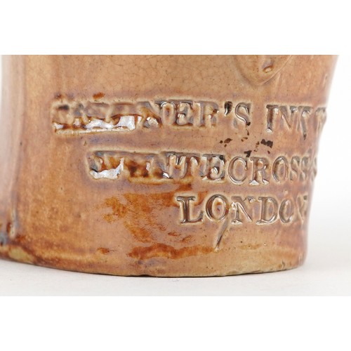 30 - A Victorian salt glazed stoneware inkwell modelled as a seated Mr. Punch, impressed For Gardner's In... 
