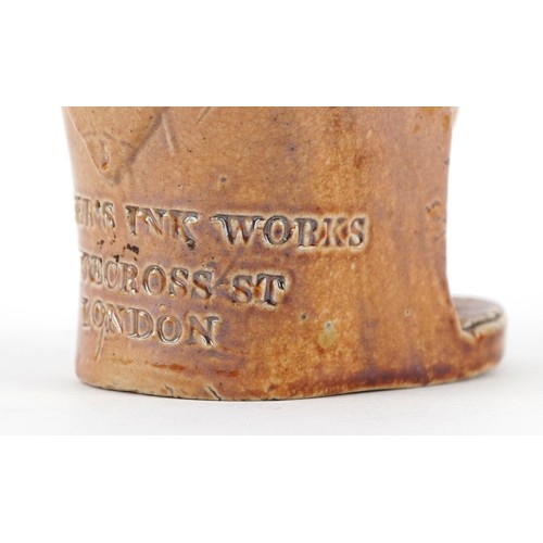 30 - A Victorian salt glazed stoneware inkwell modelled as a seated Mr. Punch, impressed For Gardner's In... 