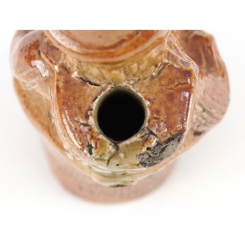 30 - A Victorian salt glazed stoneware inkwell modelled as a seated Mr. Punch, impressed For Gardner's In... 