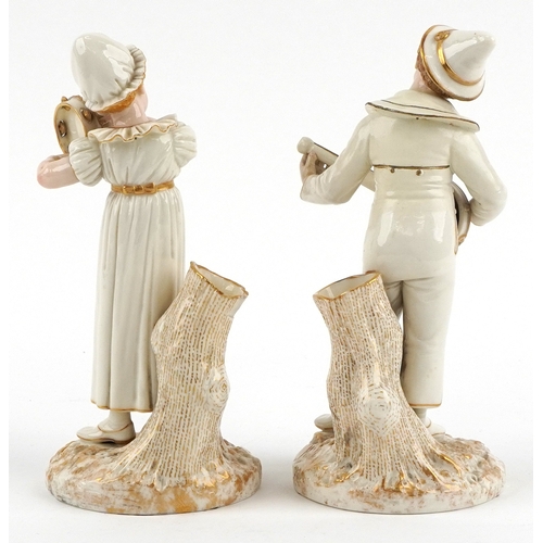  James Hadley for Royal Worcester, pair of 19th century porcelain spill vases modelled as musicians, ... 