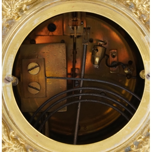  Antique French brass mantle clock cast with lion heads and Putto, striking on a gong, the enamelled ... 