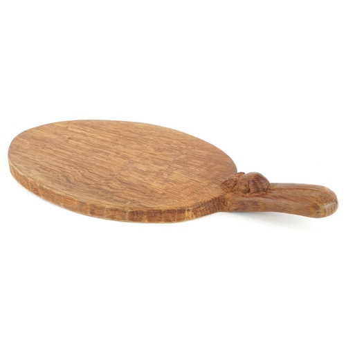 30 - Robert Mouseman Thompson, an oak cheeseboard carved with a mouse, 36cm wide.