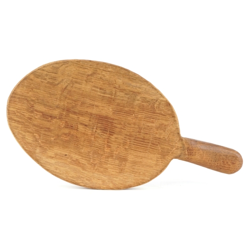 30 - Robert Mouseman Thompson, an oak cheeseboard carved with a mouse, 36cm wide.