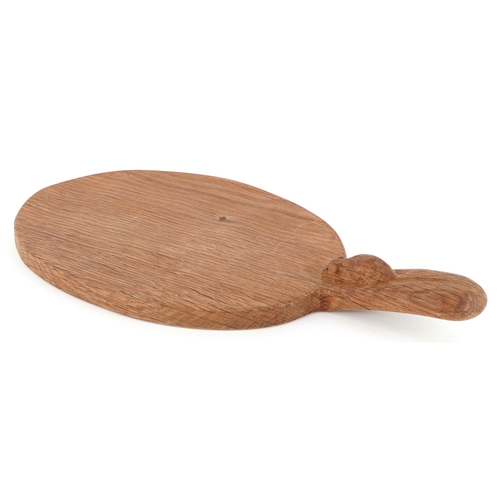  Robert Mouseman Thompson, an oak cheeseboard carved with a mouse, 38cm wide.