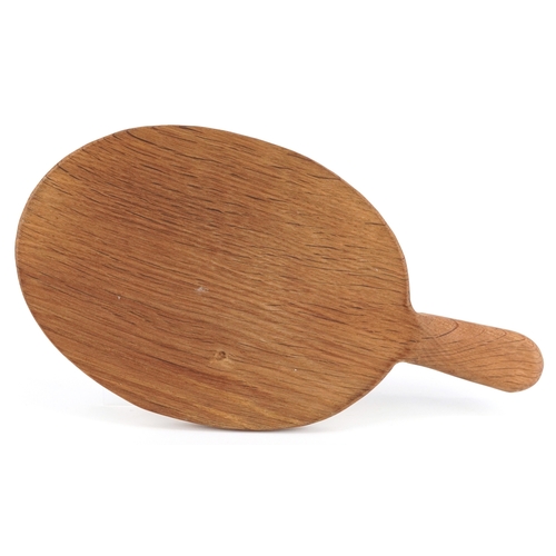  Robert Mouseman Thompson, an oak cheeseboard carved with a mouse, 38cm wide.