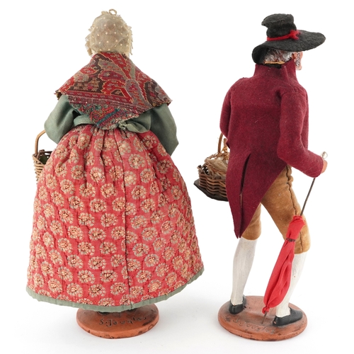  Two French terracotta dolls/figures, signed S Jouglas, the largest 29cm high.