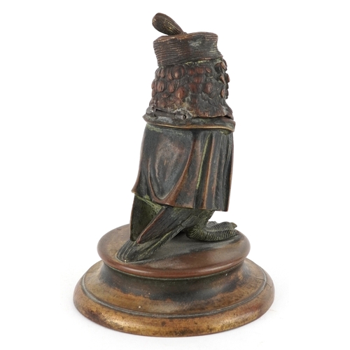  Early 20th century bronze inkwell in the form of an owl, raised on a brass plinth base, 12cm high.
