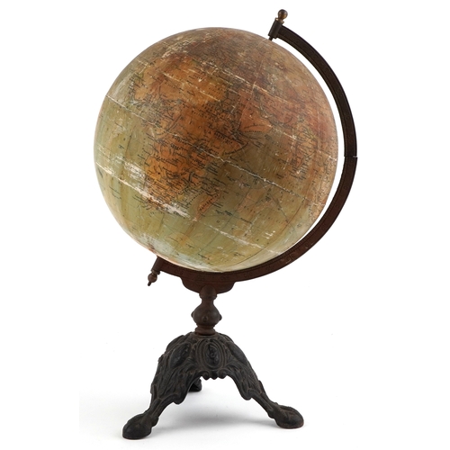  George Philip & Son twelve inch terrestrial globe raised on a cast iron tripod stand, 53cm high.