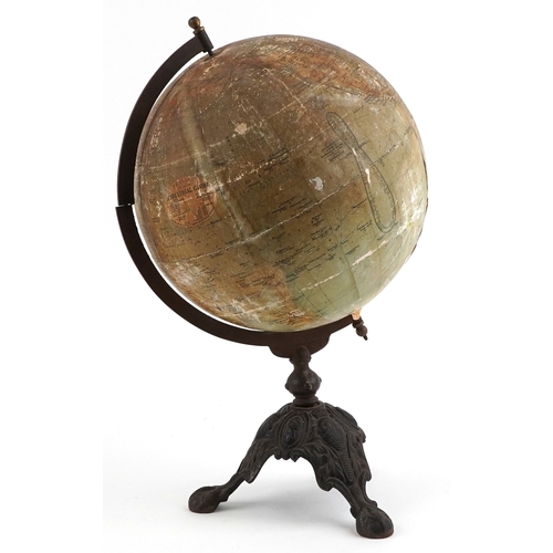  George Philip & Son twelve inch terrestrial globe raised on a cast iron tripod stand, 53cm high.