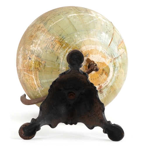  George Philip & Son twelve inch terrestrial globe raised on a cast iron tripod stand, 53cm high.