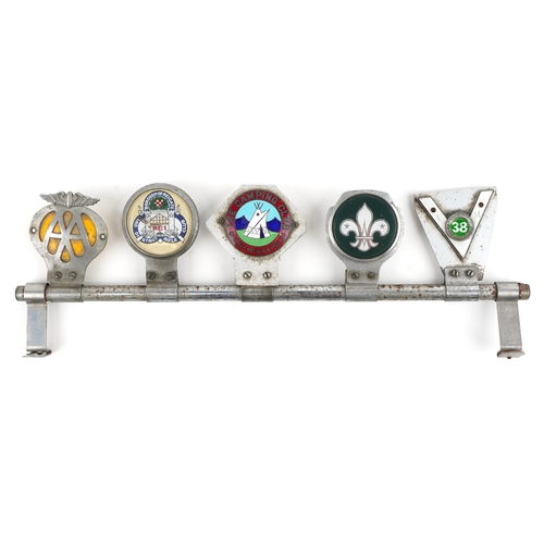 Five vintage car radiator badges mounted on a bar, including The ...
