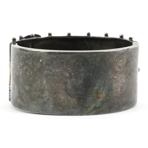  Victorian silver belt buckle design bangle with engraved floral decoration, Birmingham 1884, 6cm wid... 