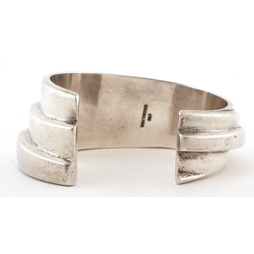  Bayanihan, Modernist sterling silver bangle, 7.5cm wide, 48.5g.