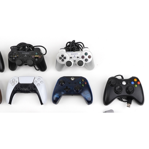 Selection of games console controllers including Sony PlayStation and ...