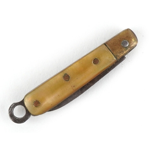50 - Miniature mother of pearl flanked folding pocket knife, 2.9cm in length closed.
