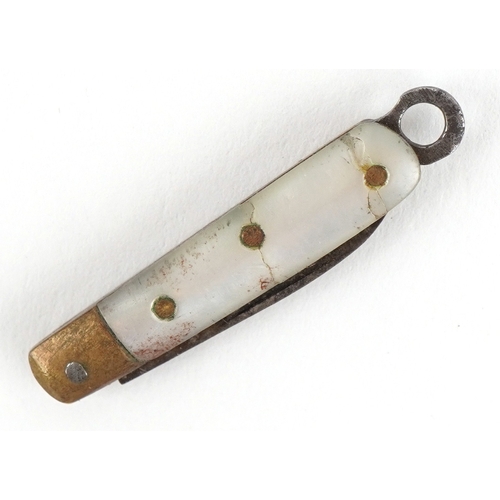 50 - Miniature mother of pearl flanked folding pocket knife, 2.9cm in length closed.