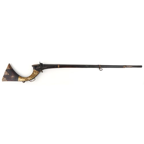 19th century Indian ball lock rifle with brass mounts, 152cm in length.