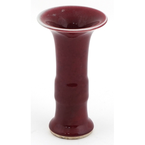 49 - Chinese porcelain bud vase having a sang de boeuf glaze, 12cm high.