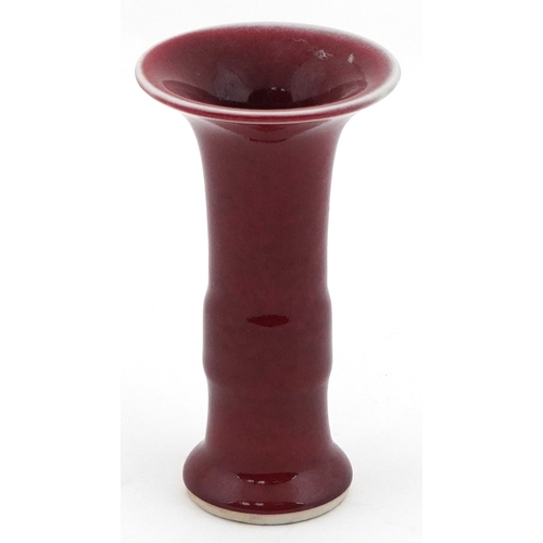 49 - Chinese porcelain bud vase having a sang de boeuf glaze, 12cm high.