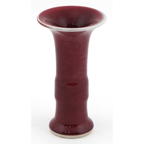49 - Chinese porcelain bud vase having a sang de boeuf glaze, 12cm high.