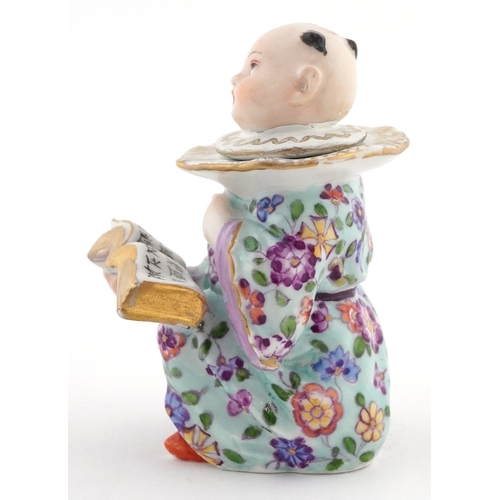 20 - 19th century Meissen style German porcelain inkwell modelled as a Chinese child with book, 9cm high.