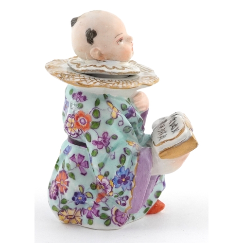 20 - 19th century Meissen style German porcelain inkwell modelled as a Chinese child with book, 9cm high.