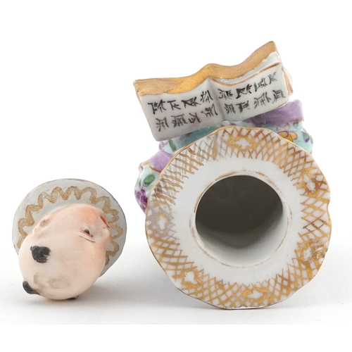 20 - 19th century Meissen style German porcelain inkwell modelled as a Chinese child with book, 9cm high.