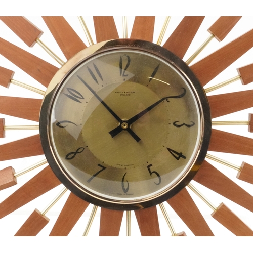 76 - Anstey & Wilson, mid century teak sunburst wall clock, 62cm in diameter.