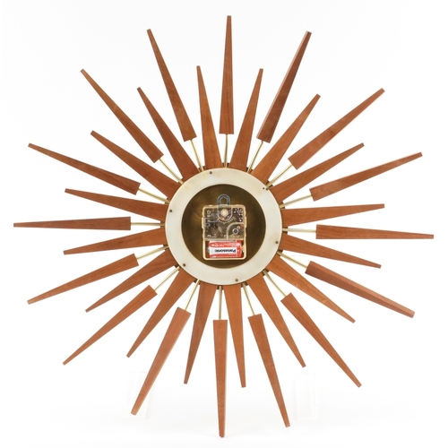 76 - Anstey & Wilson, mid century teak sunburst wall clock, 62cm in diameter.