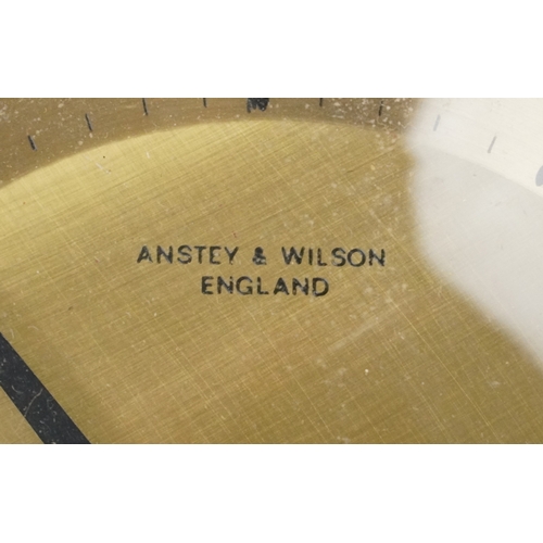 76 - Anstey & Wilson, mid century teak sunburst wall clock, 62cm in diameter.