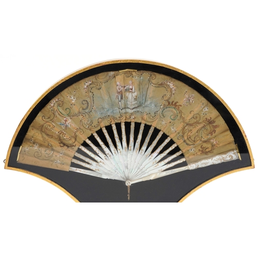 59 - Antique fan with mother of pearl guard engraved with gilt scrolls, hand painted with a courting coup... 