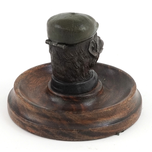 6 - Novelty cold painted inkwell in the form of a monkey, with glass liner, mounted on an oak base, 9cm ... 