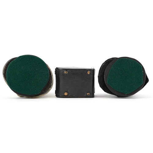 8 - Military interest inkwells, two in the form of firemen's helmets, the largest 10cm high.