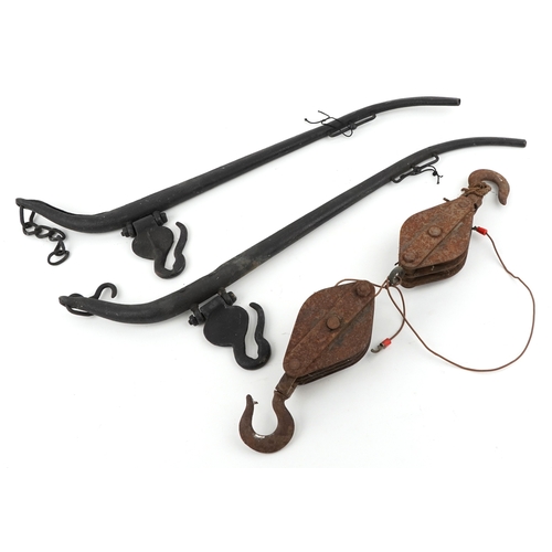2580 - Vintage cast iron horse yolks and two cast iron winch blocks.