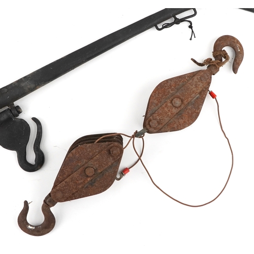 2580 - Vintage cast iron horse yolks and two cast iron winch blocks.