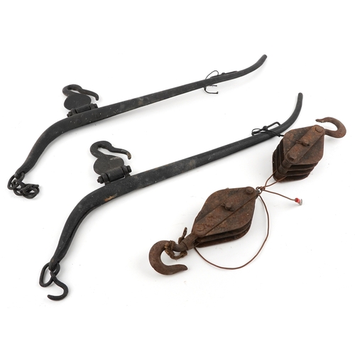 2580 - Vintage cast iron horse yolks and two cast iron winch blocks.