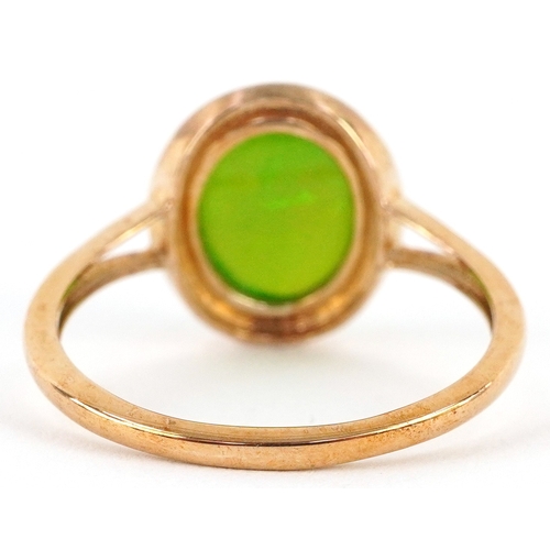 3059 - 9K gold cabochon opalescent green stone ring with split shoulders, size R, 2.6g.