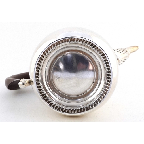 468 - Mappin & Webb, an Elizabeth II silver coffee pot with wood handle, acorn finial and decorative spout... 