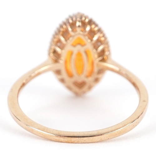 3055 - 9K gold orange stone and baguette cut diamond marquis ring, possibly fire opal, size O, 2.4g.