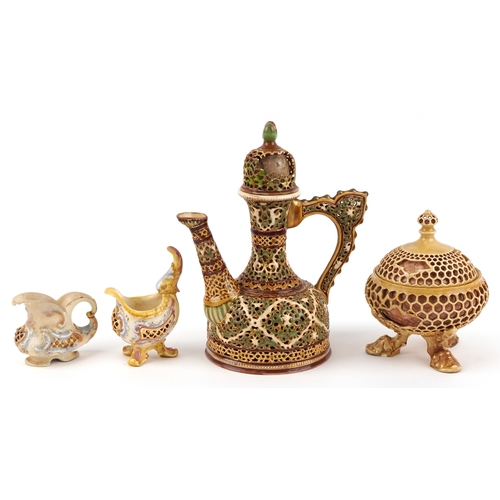 zzz ALL BROKEN zzz Zsolnay Pecs, Hungarian porcelain including a reticulated tripod jar and cover, coffee pot and two milk jugs, the largest 26cm high.