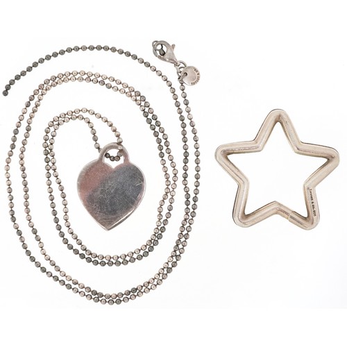 3060 - Tiffany & Co., a sterling silver star shaped split ring and love heart charm on a broken necklace, 3... 