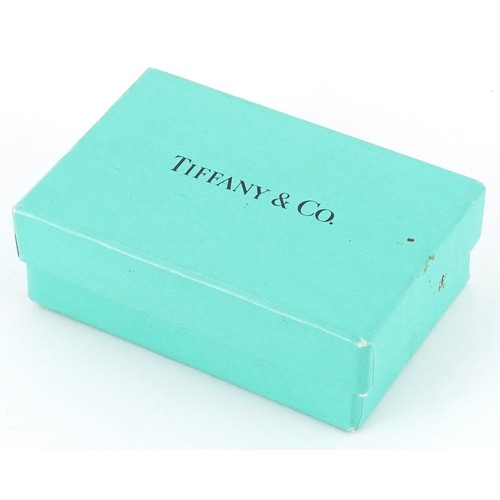 3060 - Tiffany & Co., a sterling silver star shaped split ring and love heart charm on a broken necklace, 3... 