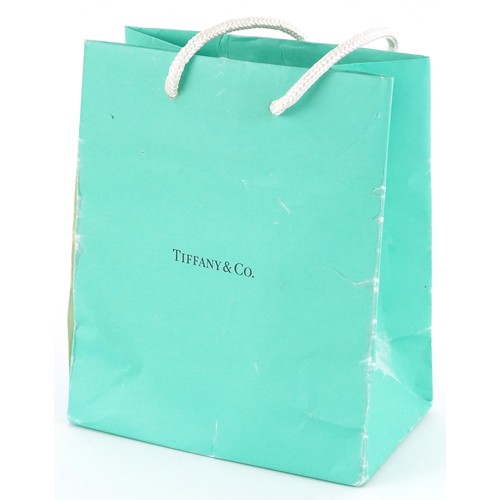 3060 - Tiffany & Co., a sterling silver star shaped split ring and love heart charm on a broken necklace, 3... 