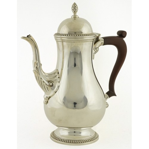 468 - Mappin & Webb, an Elizabeth II silver coffee pot with wood handle, acorn finial and decorative spout... 