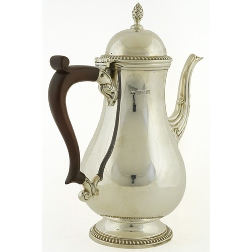 468 - Mappin & Webb, an Elizabeth II silver coffee pot with wood handle, acorn finial and decorative spout... 