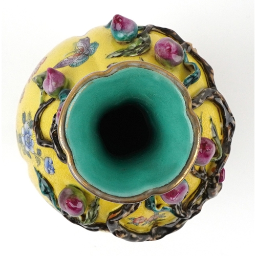 57 - Chinese porcelain bottleneck vase moulded in relief with a mango tree, hand painted onto a yellow gr... 