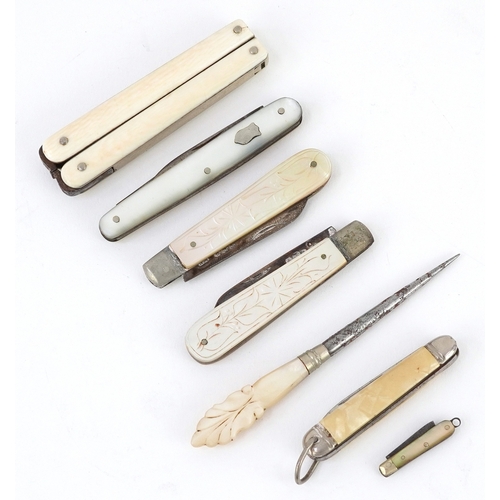 54 - Antique and later pocket tools including two mother of pearl flanked pocket knives with silver blade... 