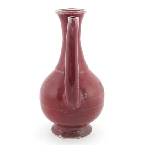 58 - Chinese porcelain red glazed ewer bearing four figure character mark to the base, 20cm high.