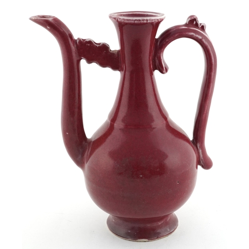58 - Chinese porcelain red glazed ewer bearing four figure character mark to the base, 20cm high.