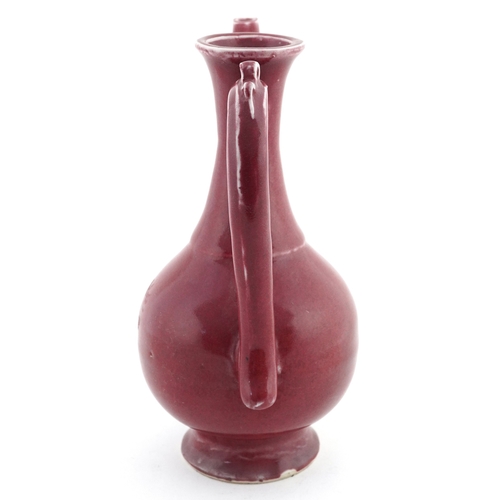 58 - Chinese porcelain red glazed ewer bearing four figure character mark to the base, 20cm high.
